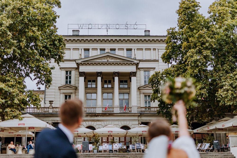 Młoda para pozuje do zdjęć podczas miejskiej sesji ślubnej w centrum Poznania